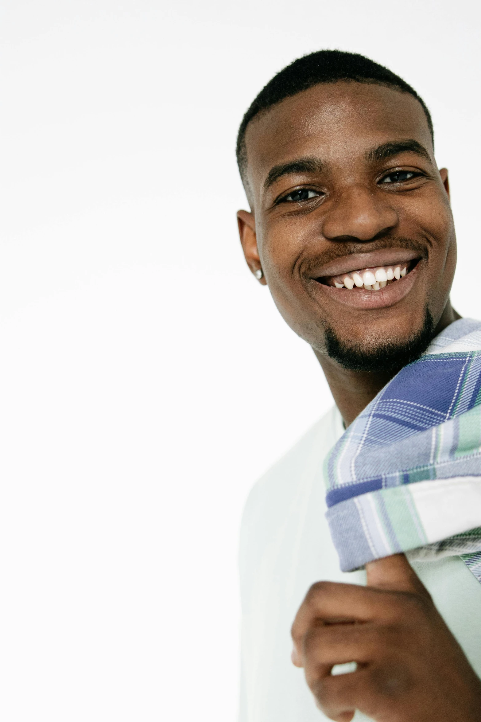 a close up of a person holding a towel, he is smiling, wearing clothes, j. h. williams iii, promotional image