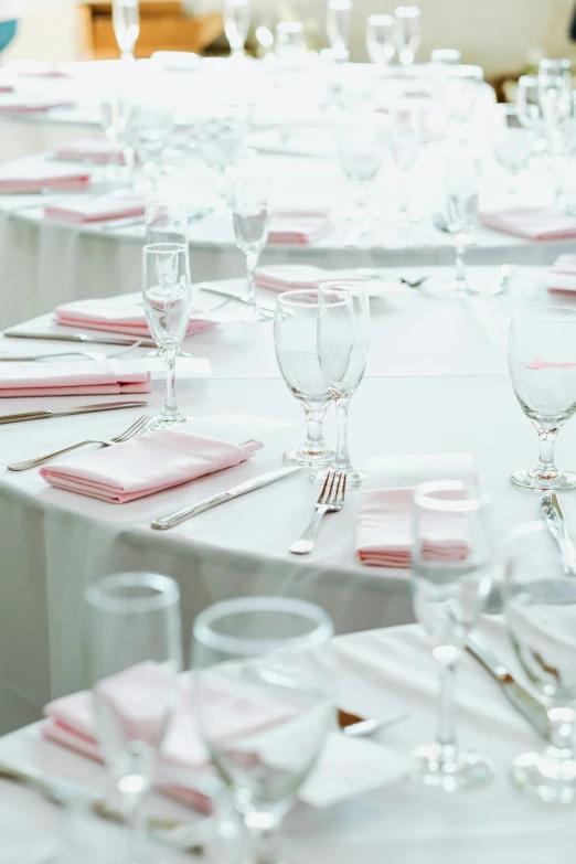 a table that has a bunch of place settings on it, white and pink cloth, ballroom, up close, upclose