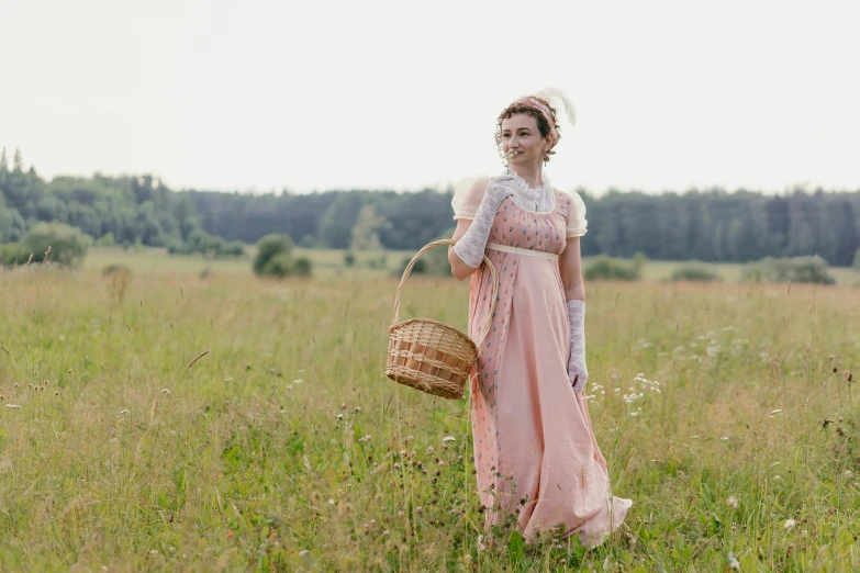 a woman standing in a field holding a basket, inspired by Cassandra Austen, pexels, renaissance, russian costume, pink, old timey, movie shot