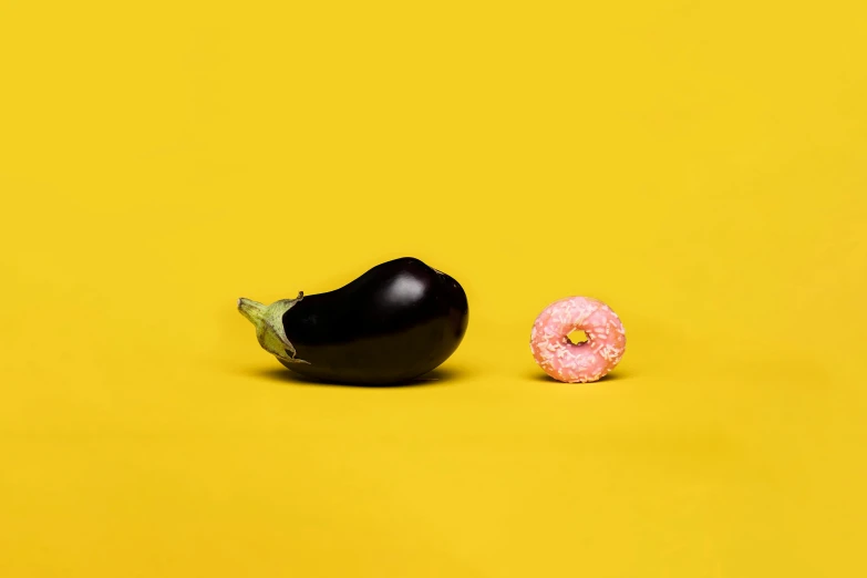 an eggplant next to a donut on a yellow background, unsplash, hyperrealism, ffffound, in the style of john baldessari, masami kurumada, 15081959 21121991 01012000 4k