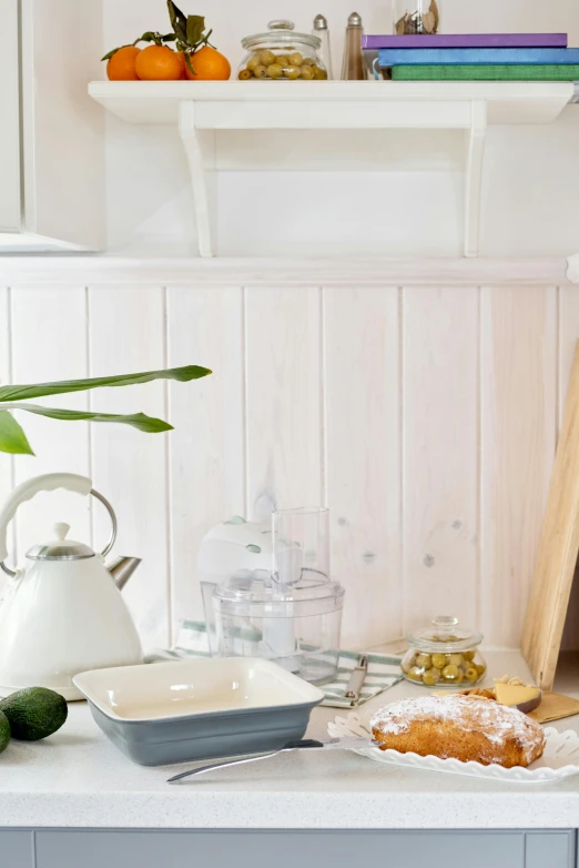 a table topped with a plate of food next to a potted plant, featured on pinterest, minimalism, white plank siding, on kitchen table, bakery, bright ambient lighting