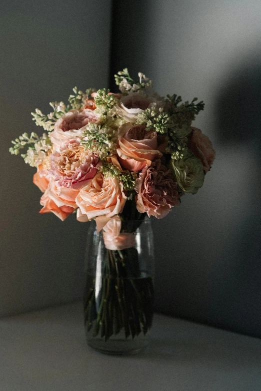 a vase filled with pink and white flowers, ethereal back light, in shades of peach, award - winning crisp details ”, moody muted colors