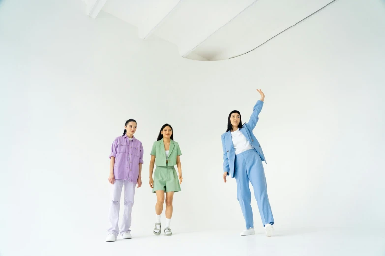 a couple of people that are standing in a room, inspired by Fei Danxu, unsplash, color field, three women, wearing a light blue suit, mid air, uniform off - white sky