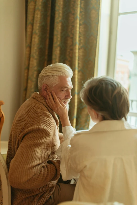 a man and a woman sitting at a table, comforting, nursing home, soft light from the side, promo image