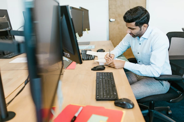 a man sitting at a desk in front of a computer, hurufiyya, ash thorp khyzyl saleem, concentration, thumbnail, profile image