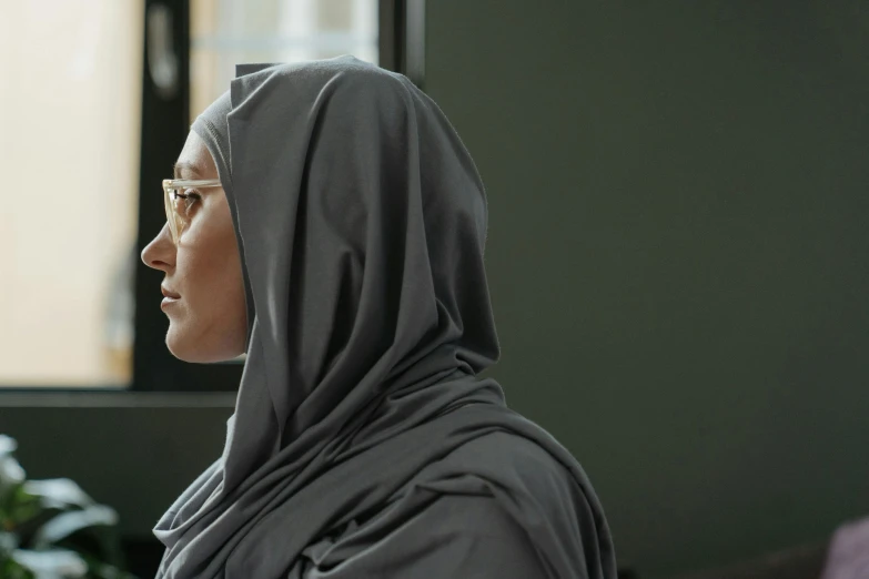 a close up of a person wearing a headscarf, standing in class, best scene, profile image, grayish