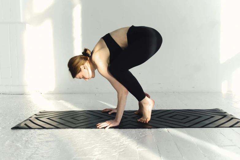 a woman doing a yoga pose on a mat, unsplash, arabesque, quadrupedal, multiple stories, soft rubber, standing