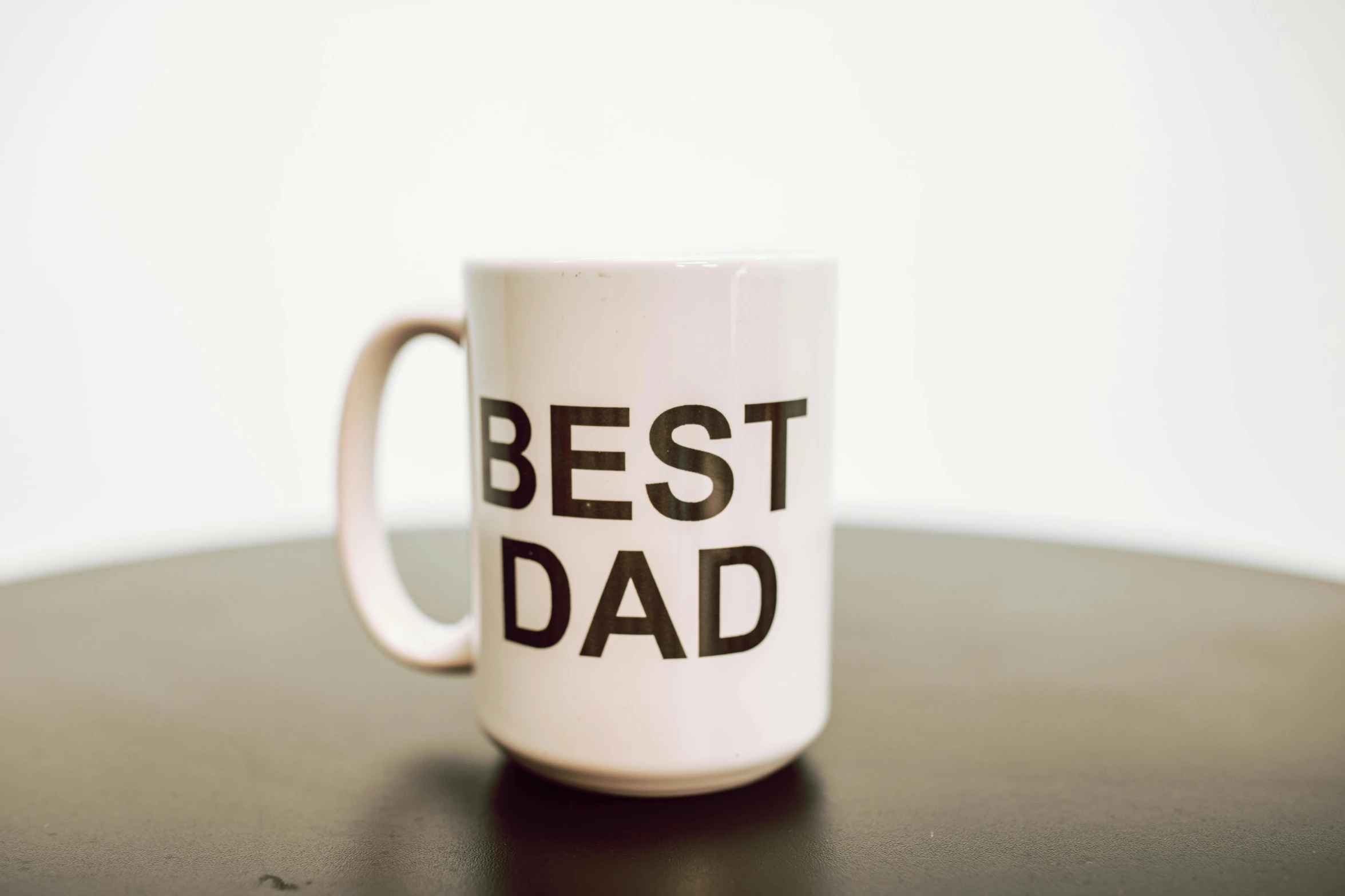 a white coffee mug with the words best dad on it, pexels, dada, product display photograph, cast, looking off to the side, panel