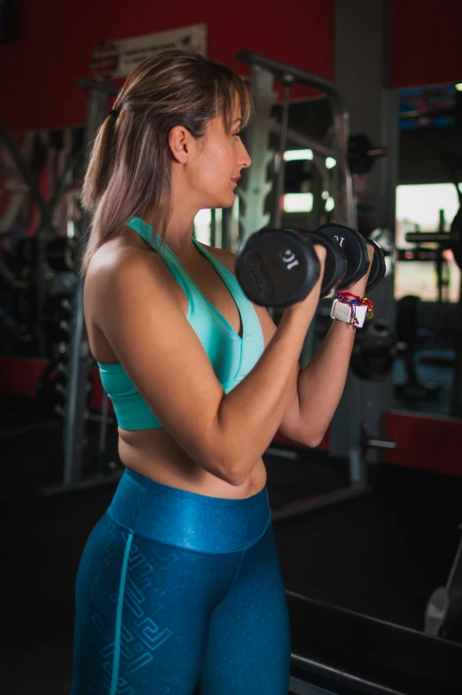 a woman lifting dumbbells in a gym, a portrait, by Robbie Trevino, pexels contest winner, profile image, lorena avarez, head to waist, mid 2 0's female
