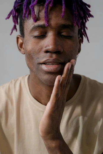 a man with purple dreadlocks on his head, trending on pexels, hyperrealism, lil uzi vert, with fingers, clean shaven, meditative