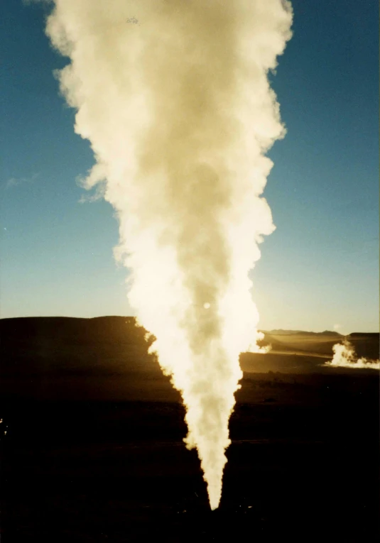 a large plume of steam rises into the sky, by Dennis Ashbaugh, nuclear art, wyoming, taken in the mid 2000s, dirt and grawel in air, cryo engine