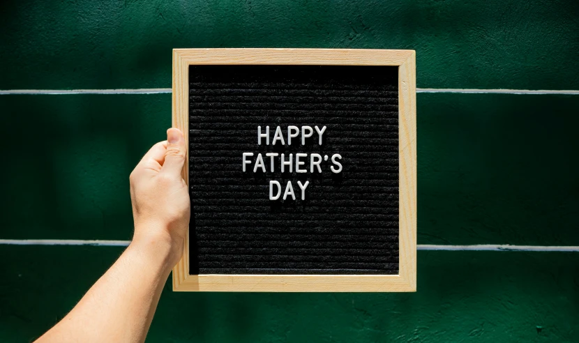 a person holding a sign that says happy father's day, pexels contest winner, square, panel of black, felt, screensaver