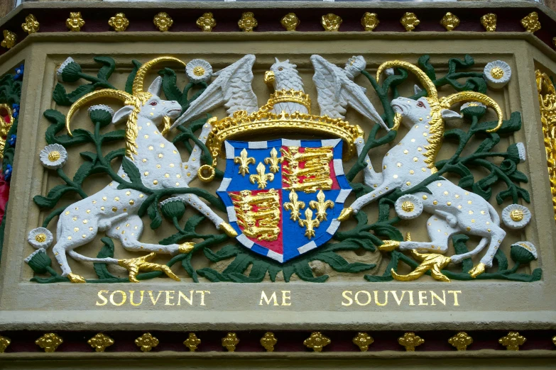 a sign on the side of a building that says souvennt me souvennt, inspired by Roelant Savery, shutterstock, sots art, coat of arms, the houses of parliament, ornate intricate crown, triumphant fate