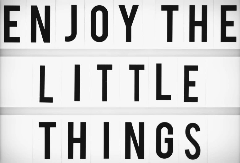 a sign that says enjoy the little things, a black and white photo, by Caroline Mytinger, funny jumbled letters, 1 6 x 1 6, joyful 4k, stanger things