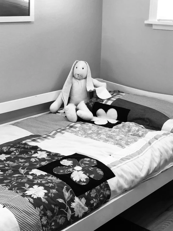 a black and white photo of a child's bedroom, a black and white photo, by Arabella Rankin, a rabbit full of hope, quilt, 2019 trending photo, sadness personified