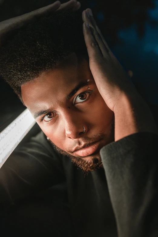 a man sitting in front of a window with his hand on his head, a character portrait, pexels contest winner, renaissance, a teen black cyborg, holding sabre, closeup headshot portrait, handsome young man