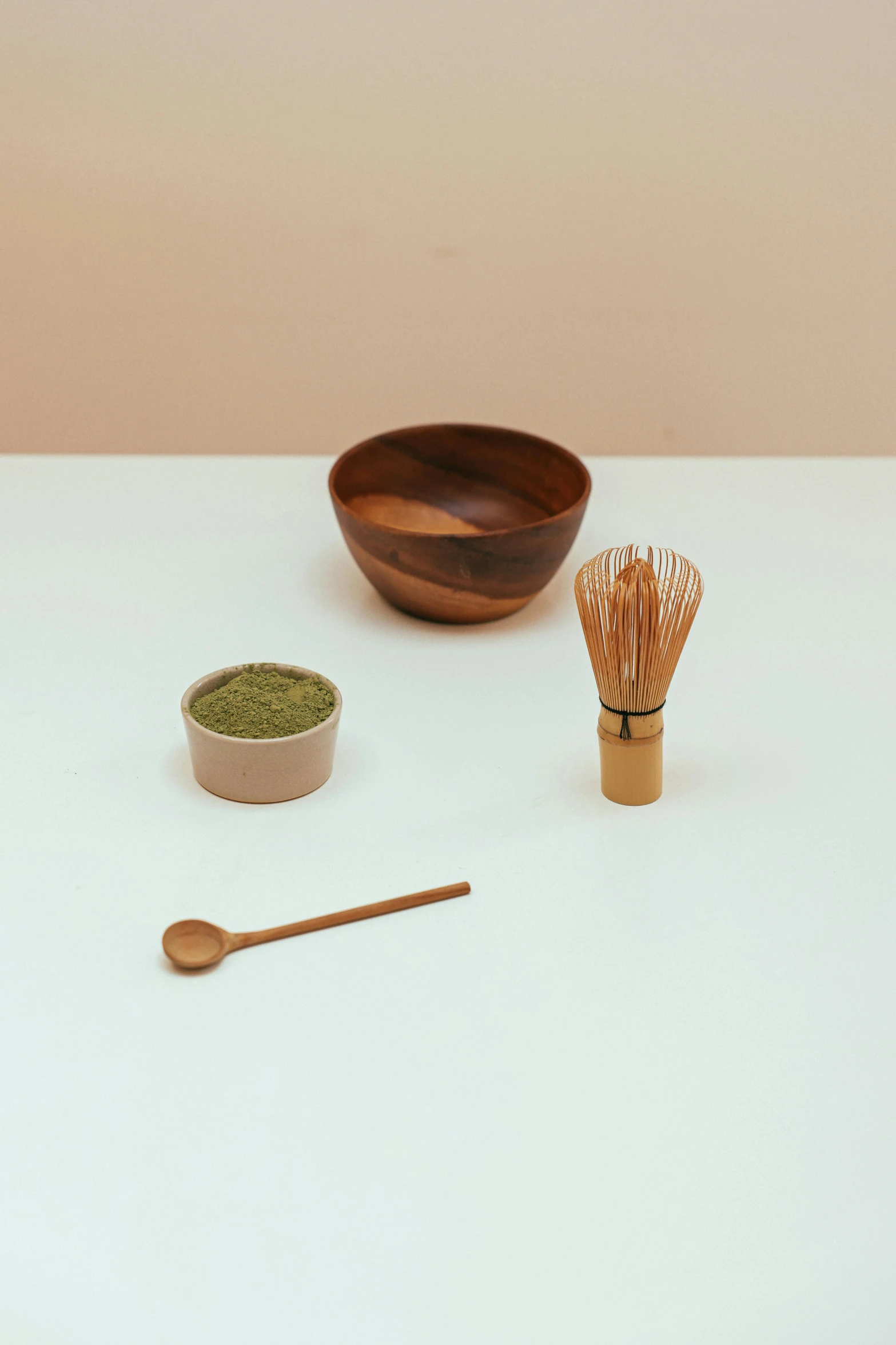 a white table topped with bowls and wooden utensils, a still life, inspired by Tōshi Yoshida, trending on unsplash, green tea, close-up product photo, made of glazed, powder