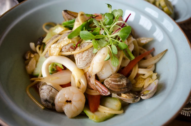 a close up of a bowl of food on a table, by Lee Loughridge, abalone, fan favorite, bo chen, pasta