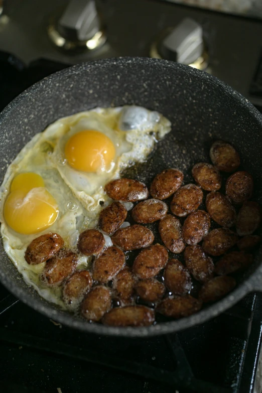 a frying pan filled with eggs and sausages, dau-al-set, ap news photo, fan favorite, beans, breeding