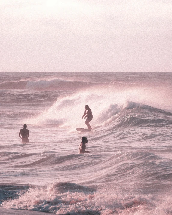 a group of people riding waves on top of surfboards, a polaroid photo, by Robbie Trevino, pexels contest winner, renaissance, pink hues, ( ( ( kauai ) ) ), rule of three, late evening