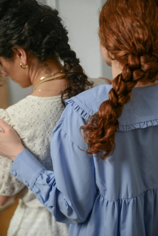 a couple of women standing next to each other, trending on pexels, renaissance, two long braids blue, wearing a linen shirt, brown curly hair, detail shot