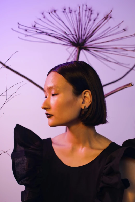 a woman standing next to a vase filled with flowers, an album cover, inspired by Gao Cen, unsplash, purple metal ears, black jewelry, angle profile portrait, asian human