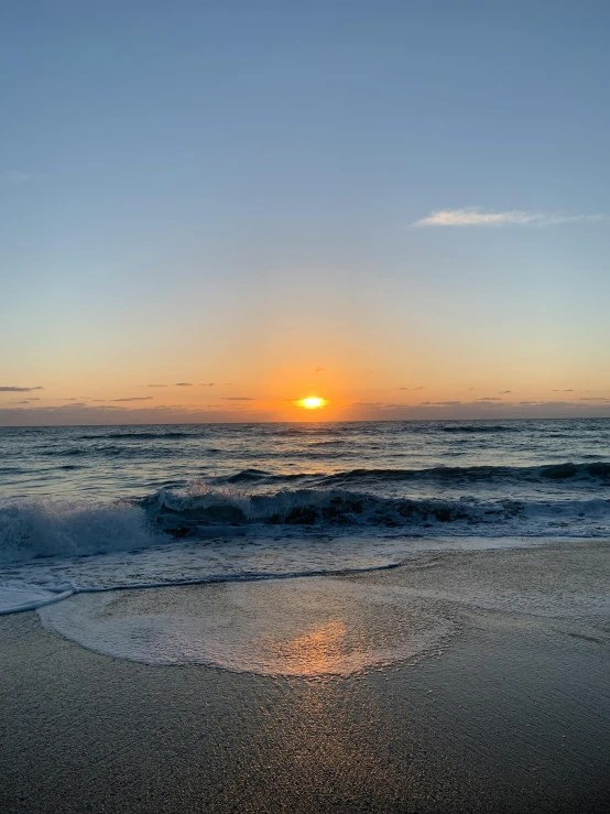 the sun is setting over the ocean on the beach, a picture, by Robbie Trevino, happening, gold coast australia, profile image