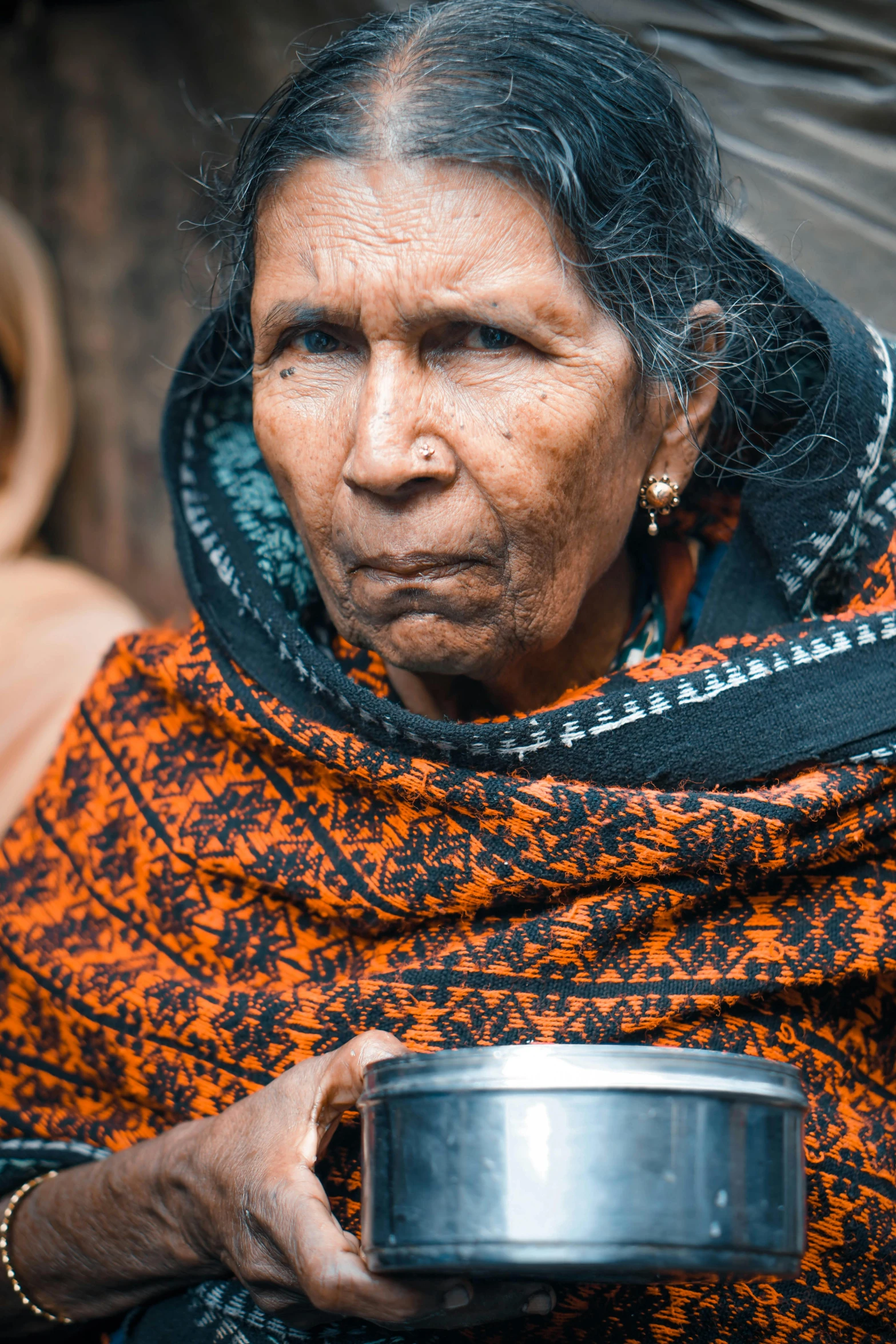 a woman holding a pot in her hands, by Jan Tengnagel, pexels contest winner, hurufiyya, an indifferent face, holding a drink, tight wrinkled cloath, indian