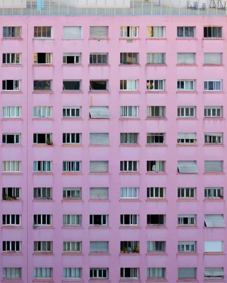 a tall pink building with lots of windows, inspired by Elsa Bleda, unsplash contest winner, brutalism, soviet apartment buildings, album cover, unsplash photo contest winner, squares