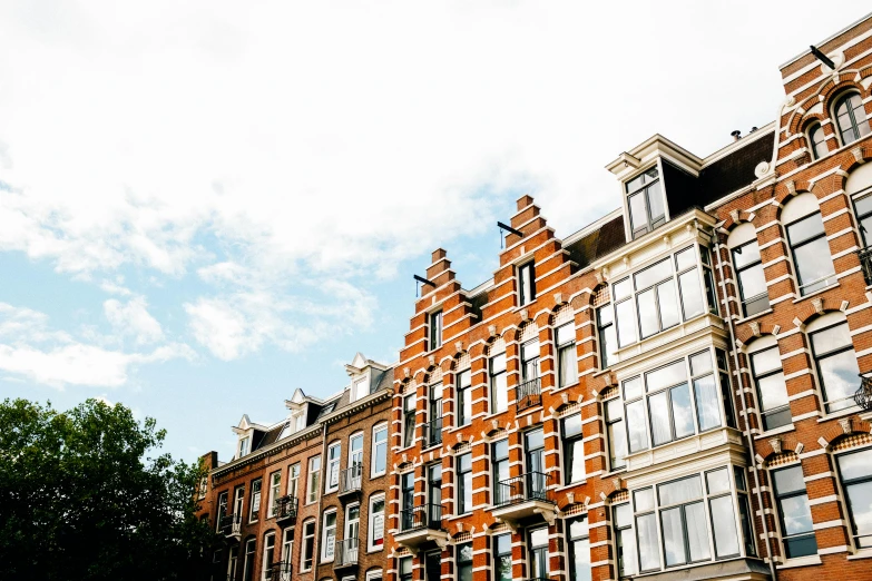 a bunch of buildings that are next to each other, a photo, by Jan Tengnagel, pexels, art nouveau, dutch masters, red bricks, full daylight, thumbnail