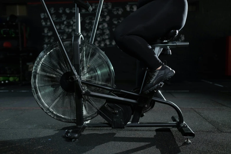 a woman riding a stationary bike in a gym, by Paul Bird, dribble, dark taint :: athletic, fan favorite, inverted, stainless steal