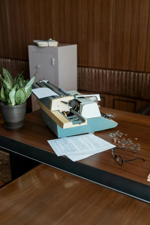 a typewriter sitting on top of a wooden table, set inside of the bank, wim crouwel, replica model, paper