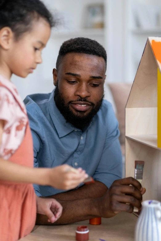 a man and a little girl sitting at a table, by artist, pexels contest winner, looking at the treasure box, doll house, varying ethnicities, cereal box