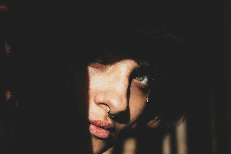 a close up of a person wearing a hat, inspired by Elsa Bleda, unsplash, dark piercing eyes, portait photo profile picture, pouty, out in the dark