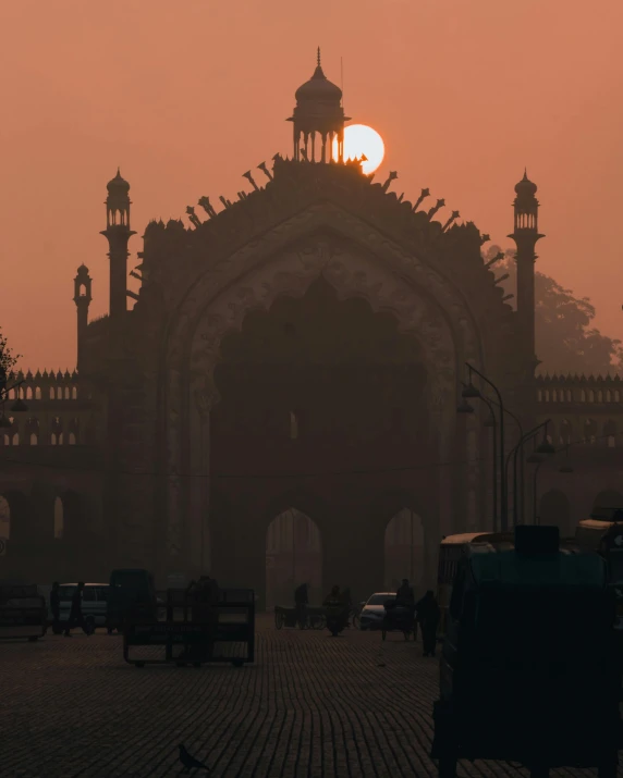 a large building with a clock tower on top of it, pexels contest winner, romanticism, morning haze, hindu aesthetic, gateway, very smoky