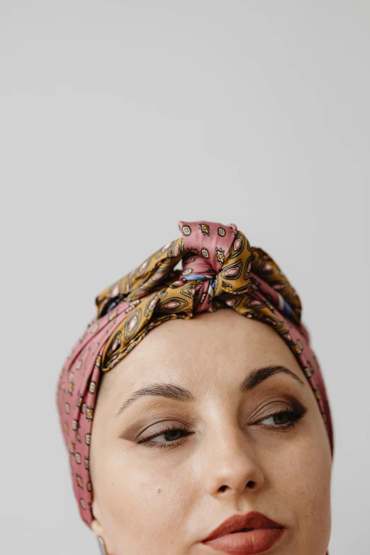 a close up of a person wearing a turban, by Nina Hamnett, hurufiyya, frontal, low profile, high quality product photo, patterned