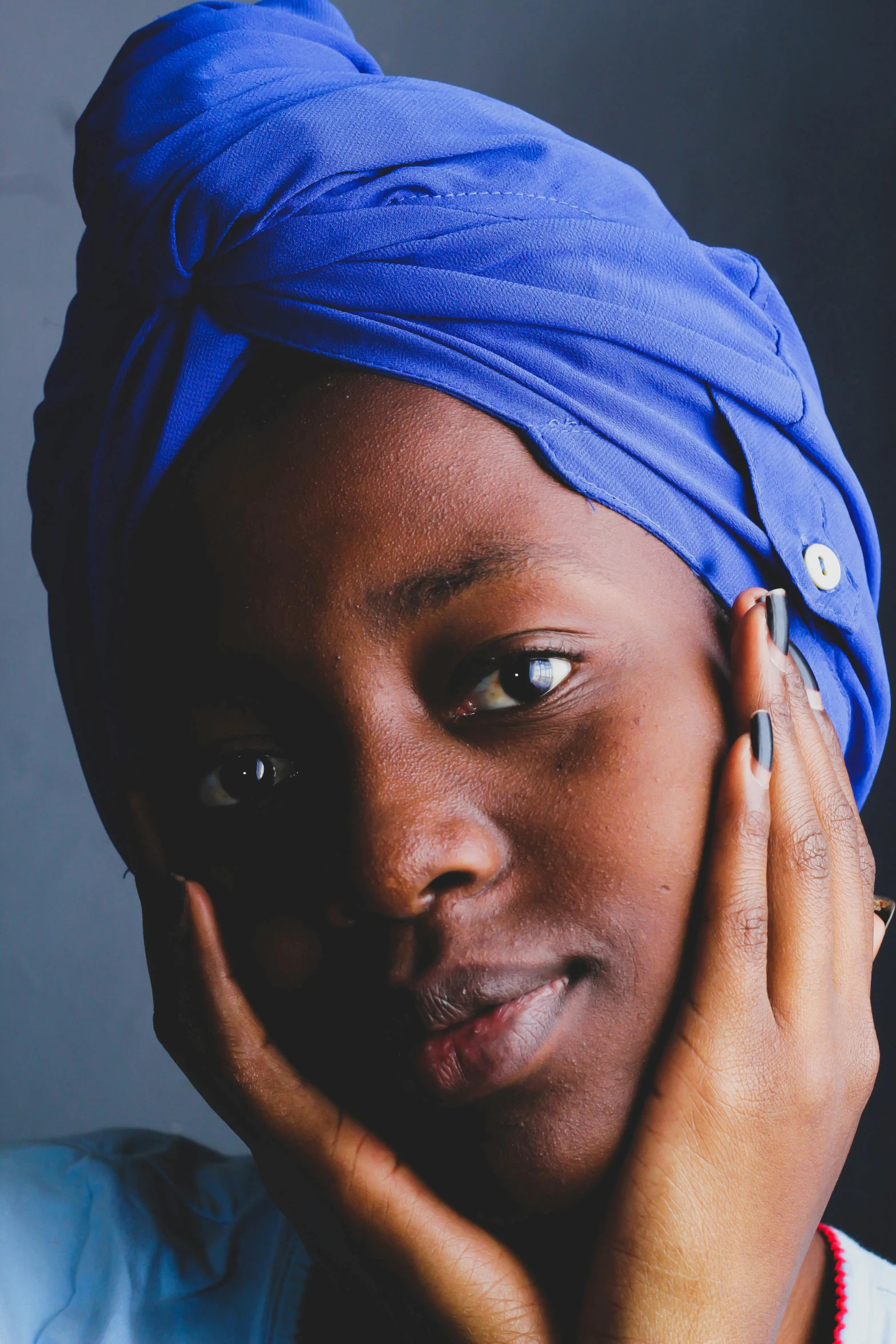 a woman with a blue turban on her head, an album cover, inspired by Makoto Aida, trending on unsplash, maria borges, hand on cheek, portrait mode photo, 2019 trending photo