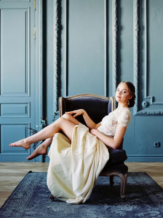 a woman sitting in a chair in a room, a portrait, inspired by Balthus, trending on unsplash, baroque, in wedding dresses, elegant feet, ukraine. professional photo, marie - gabrielle capet style