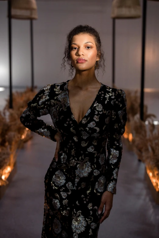 a woman in a black dress posing for a picture, intricate glow accents, curated collections, f / 2 0, runway photo