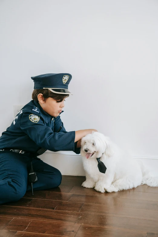 a police officer petting a small white dog, a colorized photo, by Nicolette Macnamara, trending on unsplash, conceptual art, boys, fancy dress, sydney hanson, havanese dog