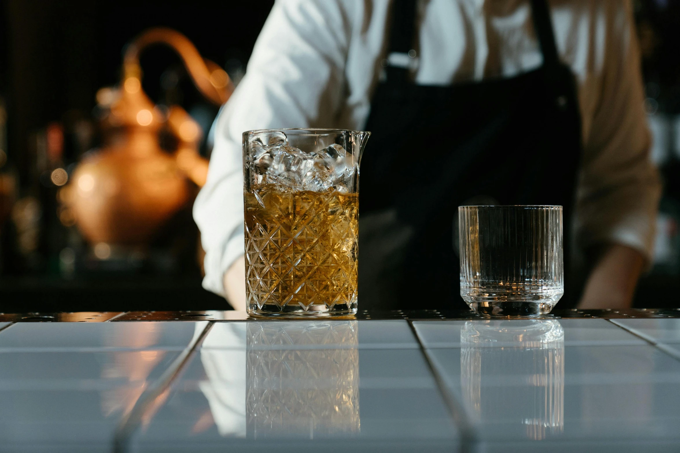 a bartender preparing a drink at a bar, inspired by Richmond Barthé, unsplash, whisky, profile image, brown, person made out of glass