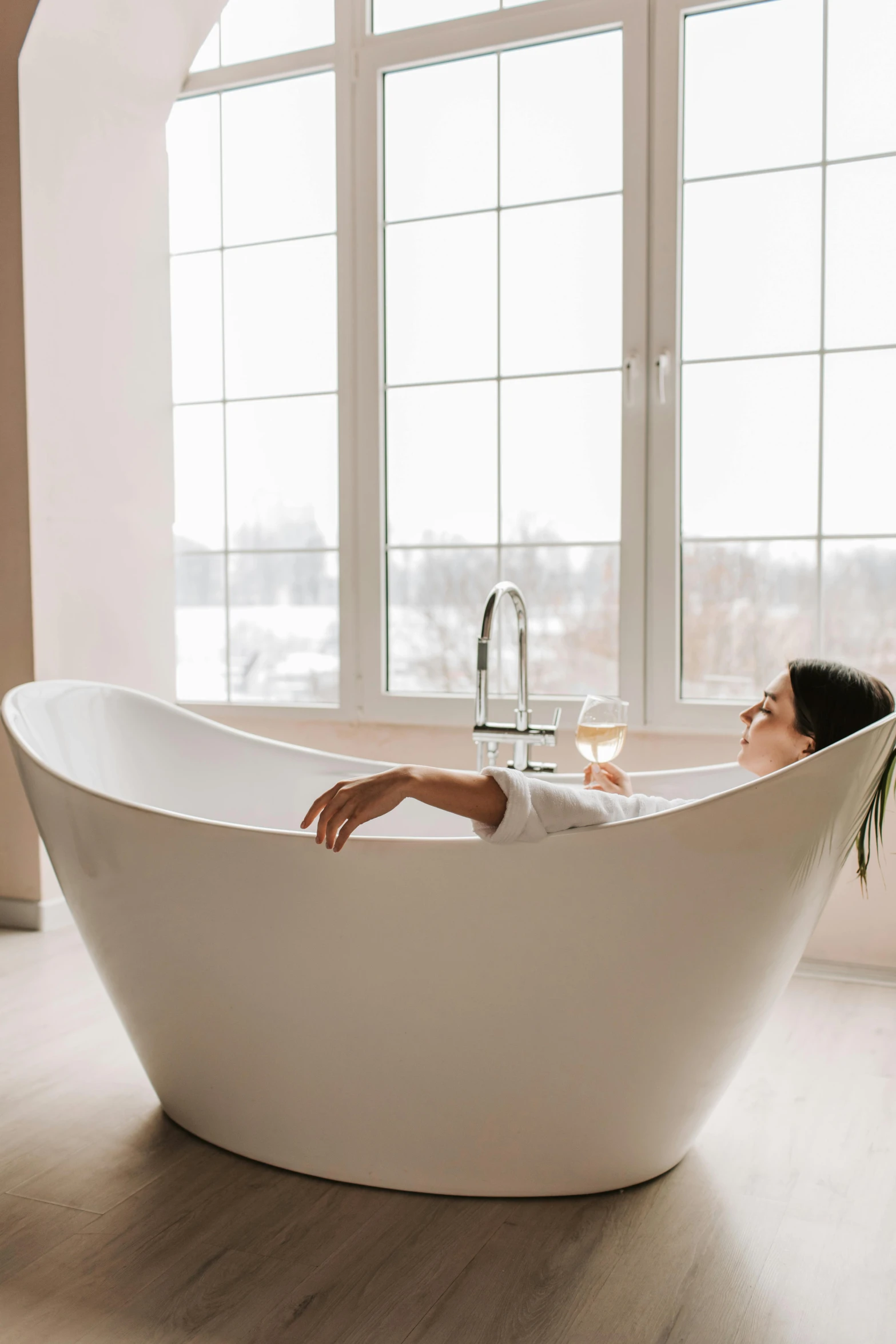 a woman sitting in a bathtub in front of a window, trending on pexels, renaissance, humans sleeping in healing pods, winter snow, glossy white, drinking