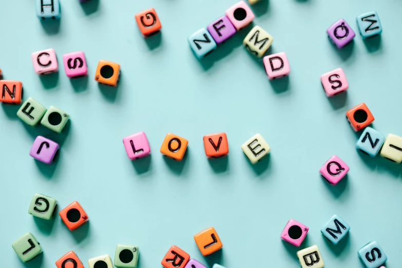 colorful wooden letters spelling i love you on a blue background, by Emma Andijewska, trending on pexels, letterism, squares, mdma, love is the most relevant theme, screenshot from game