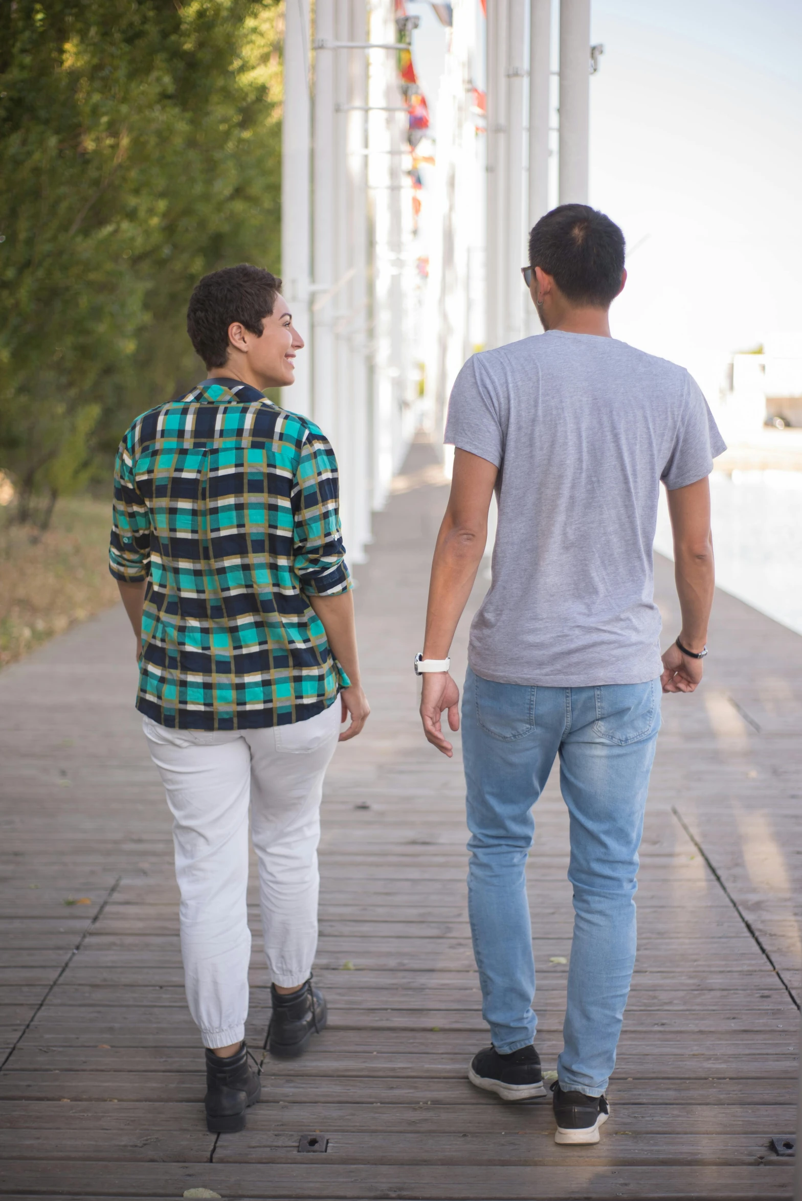 a man and a woman walking down a sidewalk, lgbtq, near a jetty, josan gonzalez and tyler edlin, thin young male