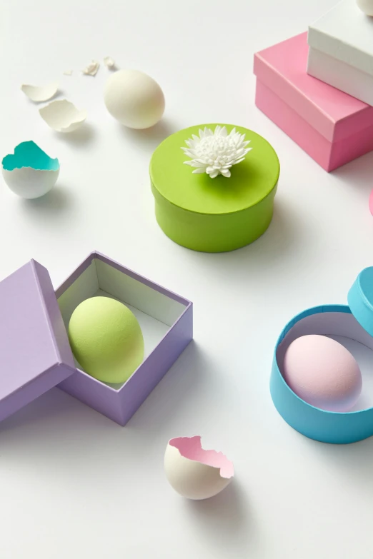 a white table topped with colorful boxes and eggs, inspired by Eden Box, papercraft, beauty shot, pastel green, heian