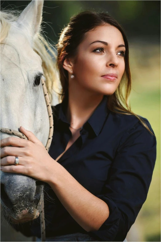 a woman standing next to a white horse, engagement ring ads, wearing a dark blue polo shirt, wearing elegant jewellery, wearing a linen shirt