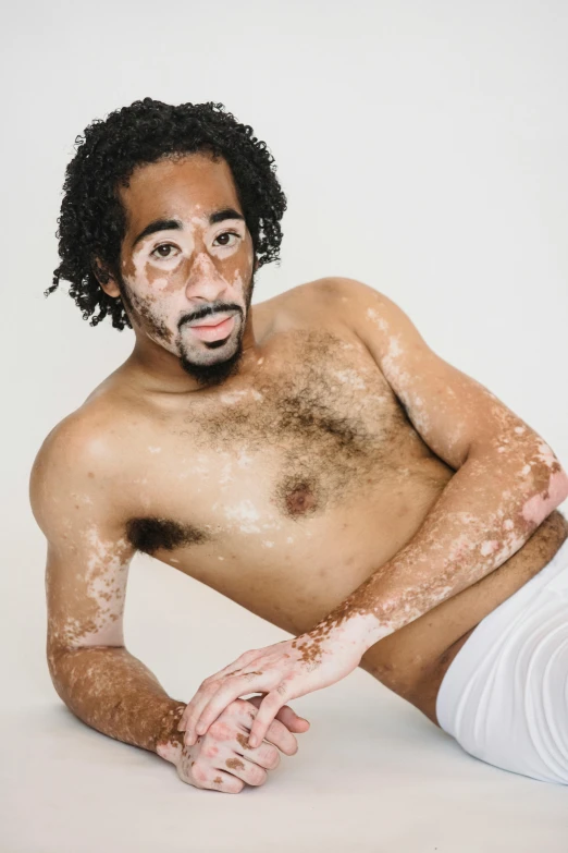 a man sitting on the ground covered in dirt, by Jessie Alexandra Dick, wearing white leotard, on a white table, light brown skin!, on clear background