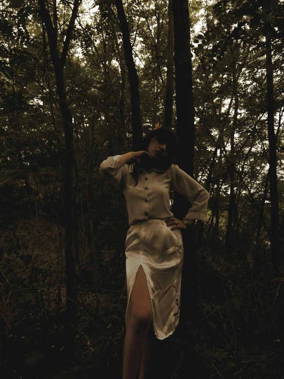 a woman in a white dress standing in the woods, an album cover, unsplash, wearing dark silk, white silky outfit, ✨🕌🌙, taken on iphone 1 3 pro