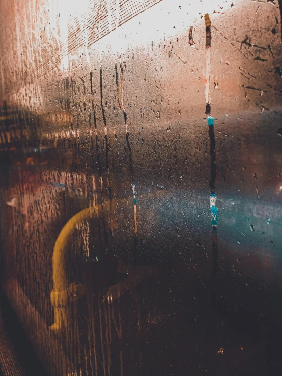 a close up of a window with rain on it, inspired by Elsa Bleda, unsplash contest winner, lyrical abstraction, reflecting light in a nightclub, bus stop on a rainy day, promo image, faded glow