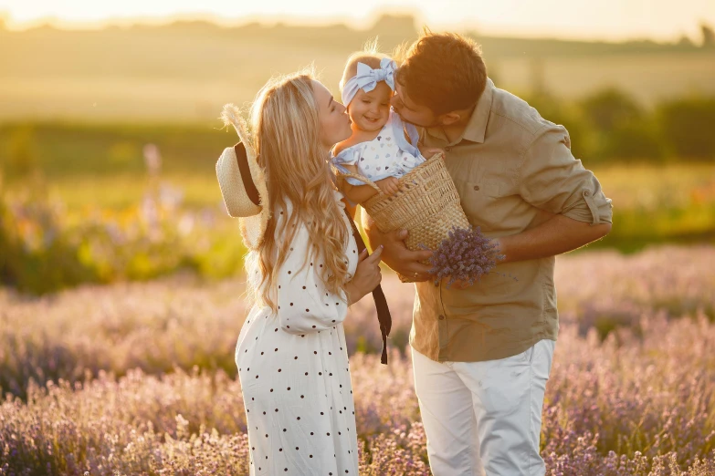 a man and woman holding a baby in a lavender field, pexels contest winner, white, thumbnail, evening sunlight, hunting